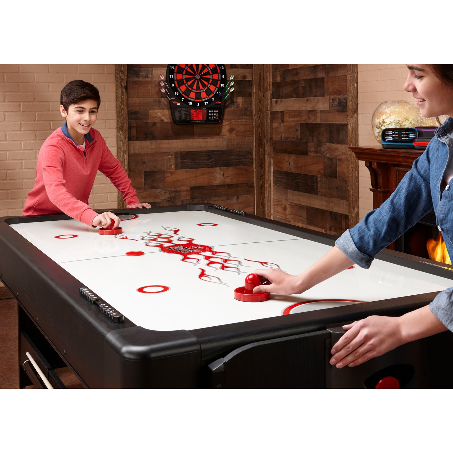 two kids playing air hockey on the Fat Cat Original 3-in-1 Blue 7' Pockey™ Multi-Game Table ball in play